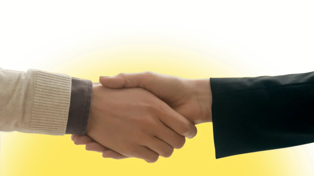 Handshake between two people, representing a partnership or agreement.